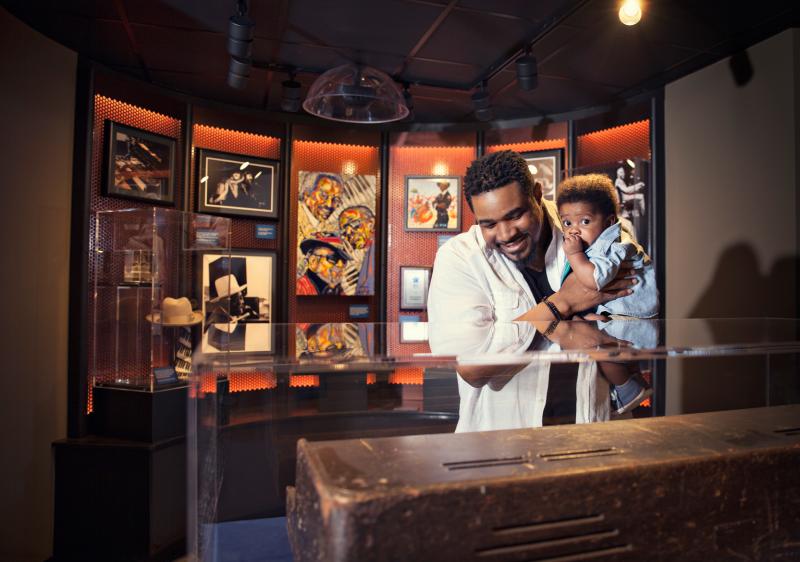 Father and son in front of an exhibit at the Blues Hall of Fame