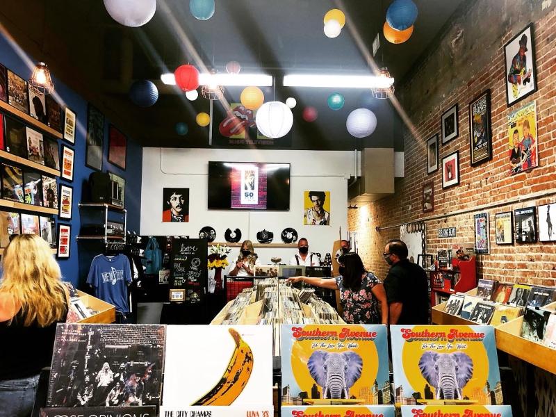 record store inside with racks of records and multicolored paper lanterns