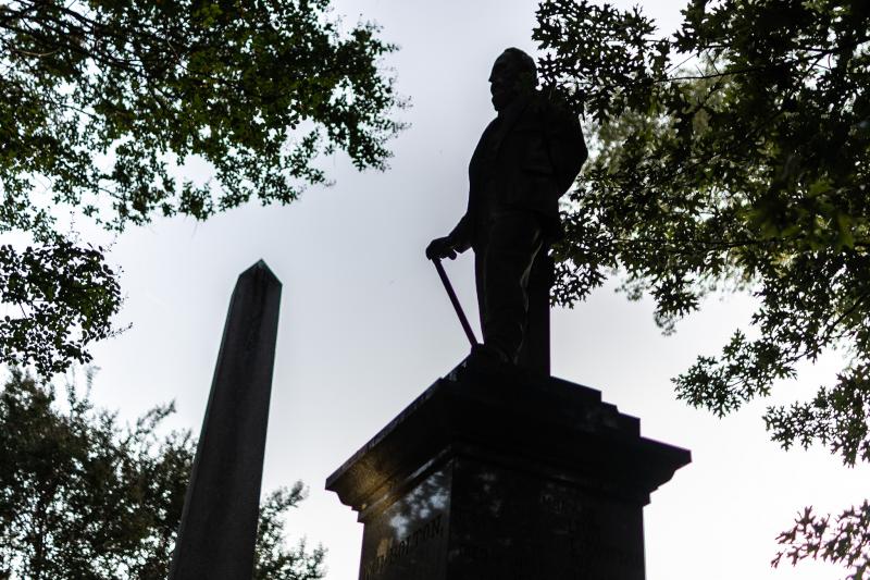 silhouette of statue of a man at Elmwood Cemetery