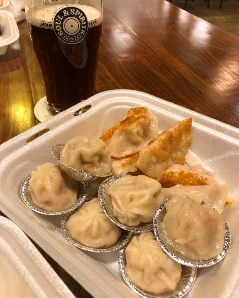 soup dumplings and potstickers with a dark beer