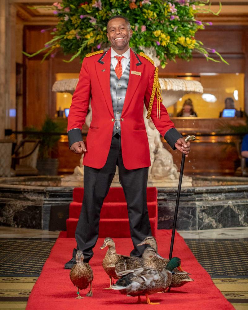 Peabody Memphis hotel Duckmaster Kenon Walker with the Peabody ducks | Courtesy of The Peabody Memphis