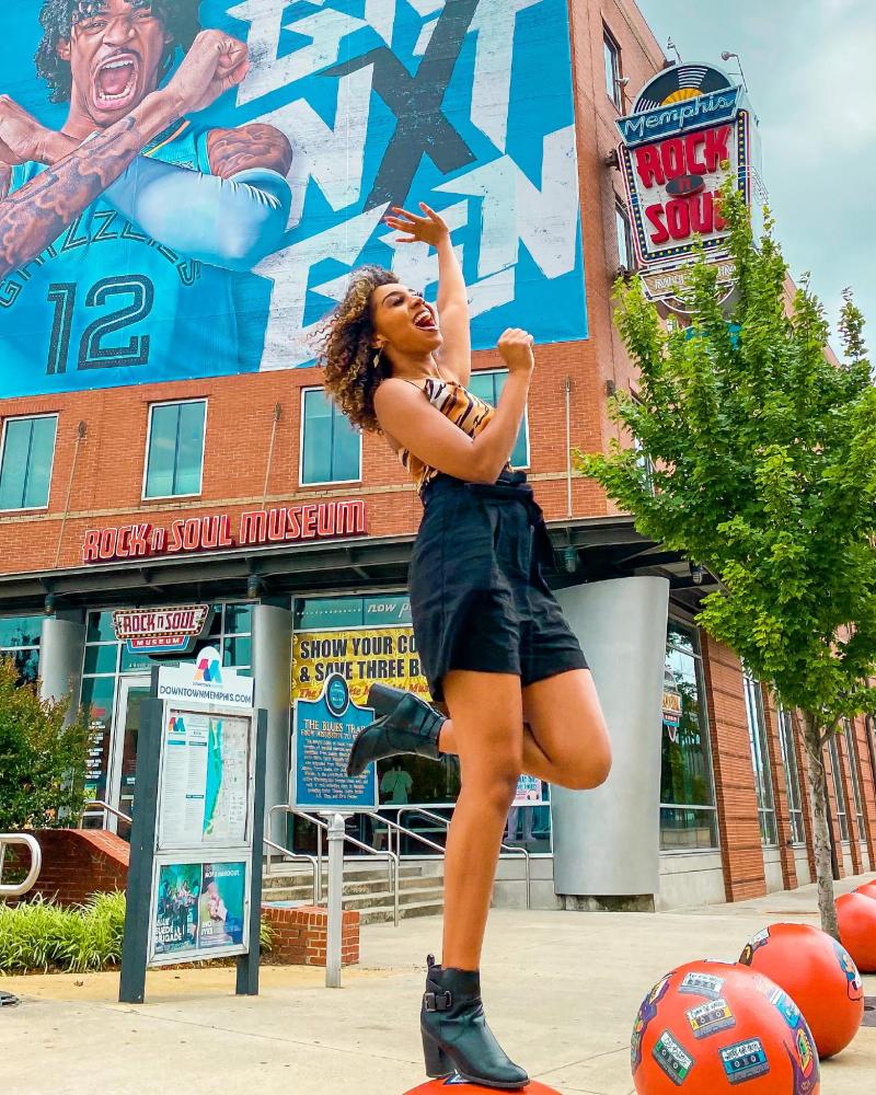 visitor in front of rock n soul with ja morant poster
