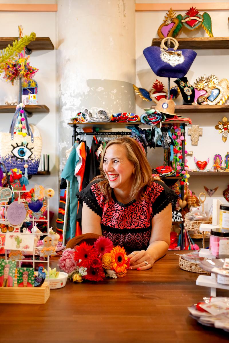 woman laughing at shop desk