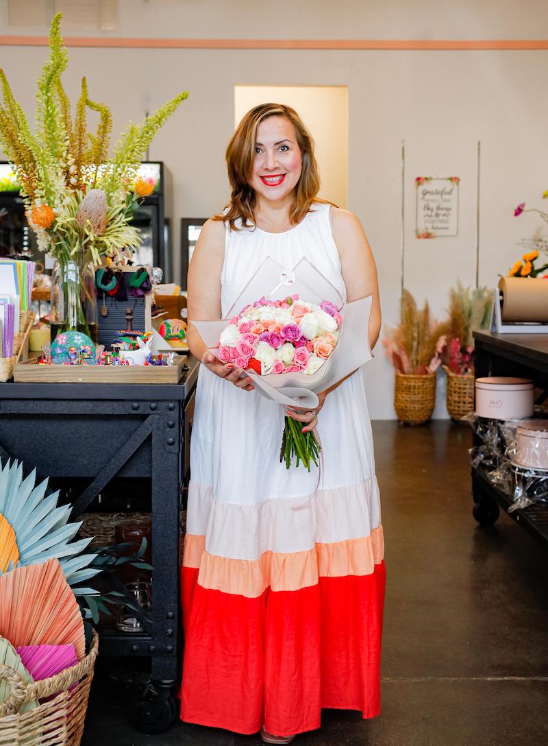 Miriam standing with bouquet