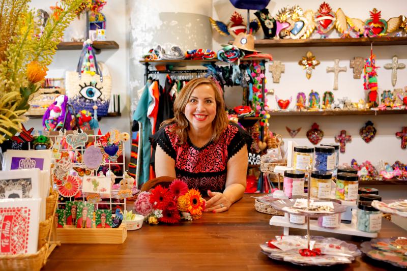 Miriam sitting at colorful shop desk