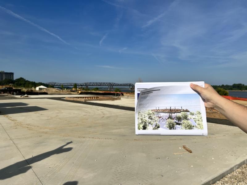 tom lee park construction 6 man holding rendering of Civic Canopy