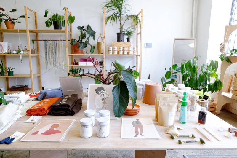 Plant and Gift shop Memphis table and shelves with plants and white jars of body products