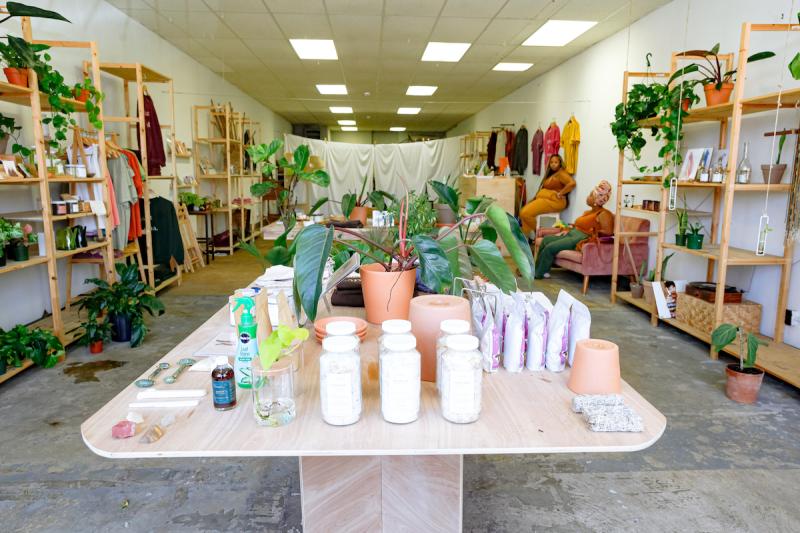 Plant and Gift shop Memphis table and shelves with plants and white jars of body products