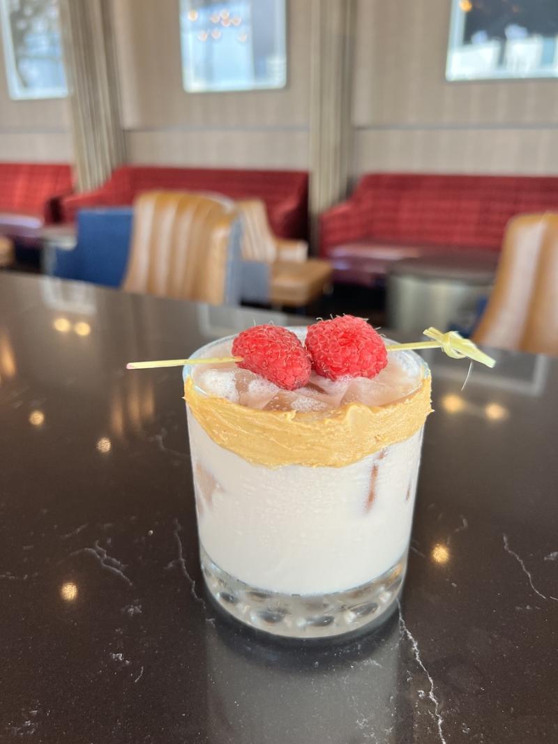 raspberry drink with peanut butter and raspberry garnish