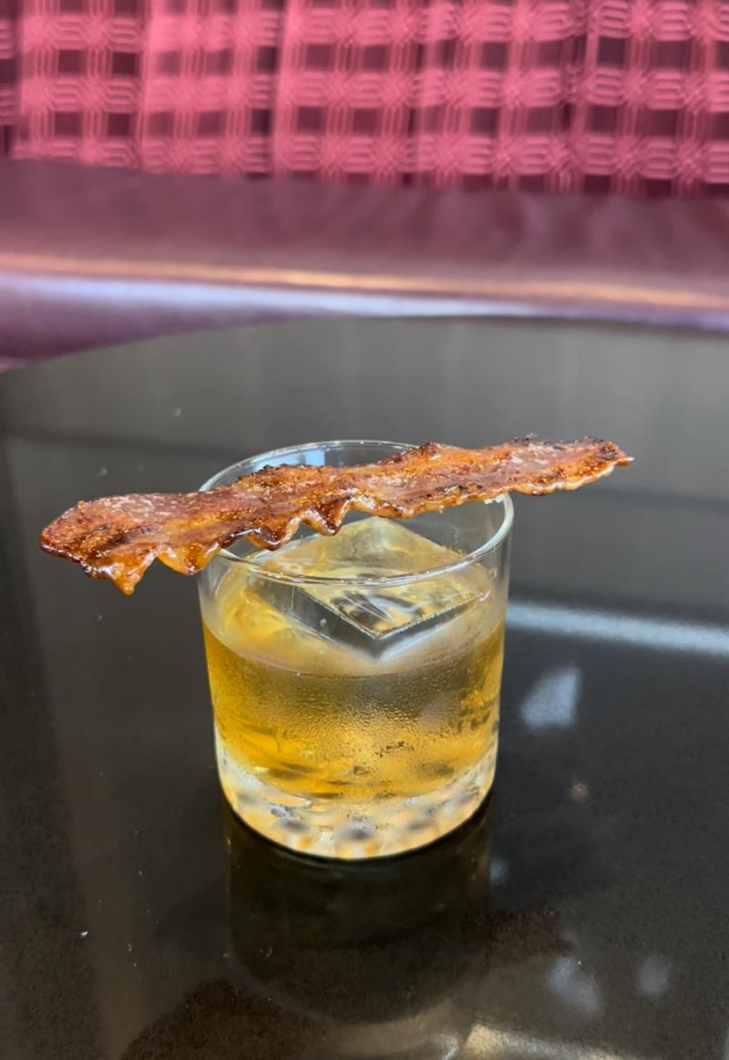 whiskey cocktail with bacon on top