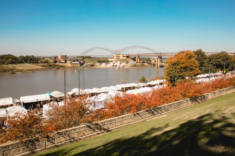 Riverside Dr. with tents for RiverArtsFest with the Hernando de Soto "M" bridge in the background.