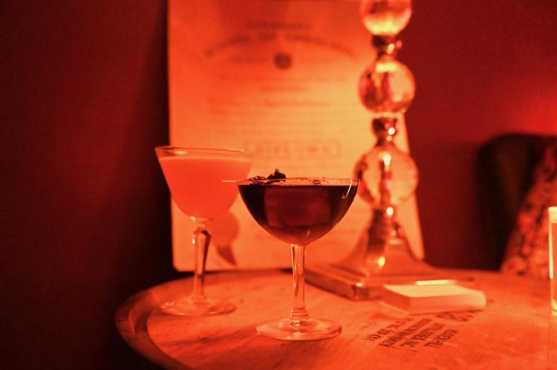 two cocktails in dark red area of memphis whistle