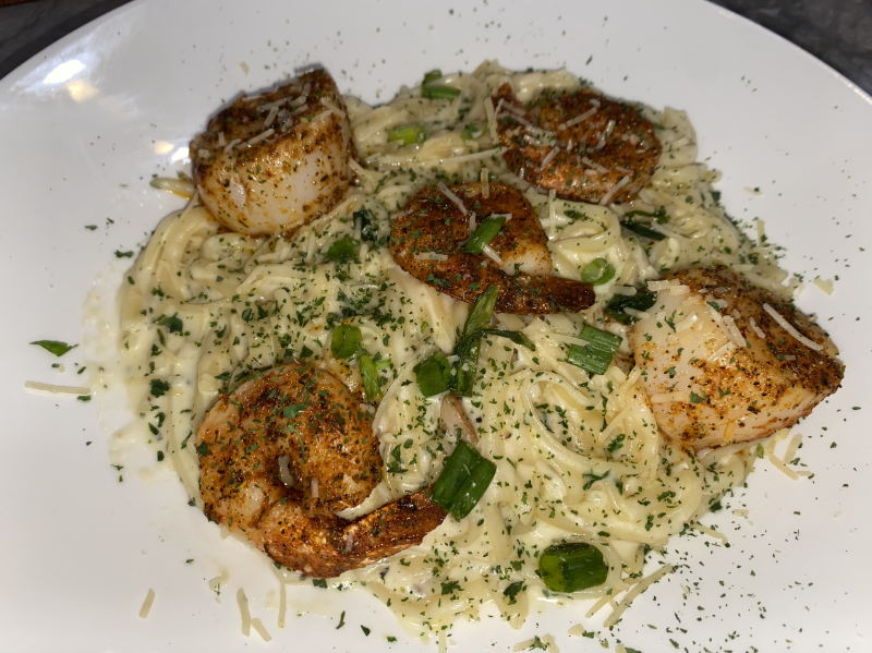 seafood linguini pasta in a bowl with seasoned shrimp