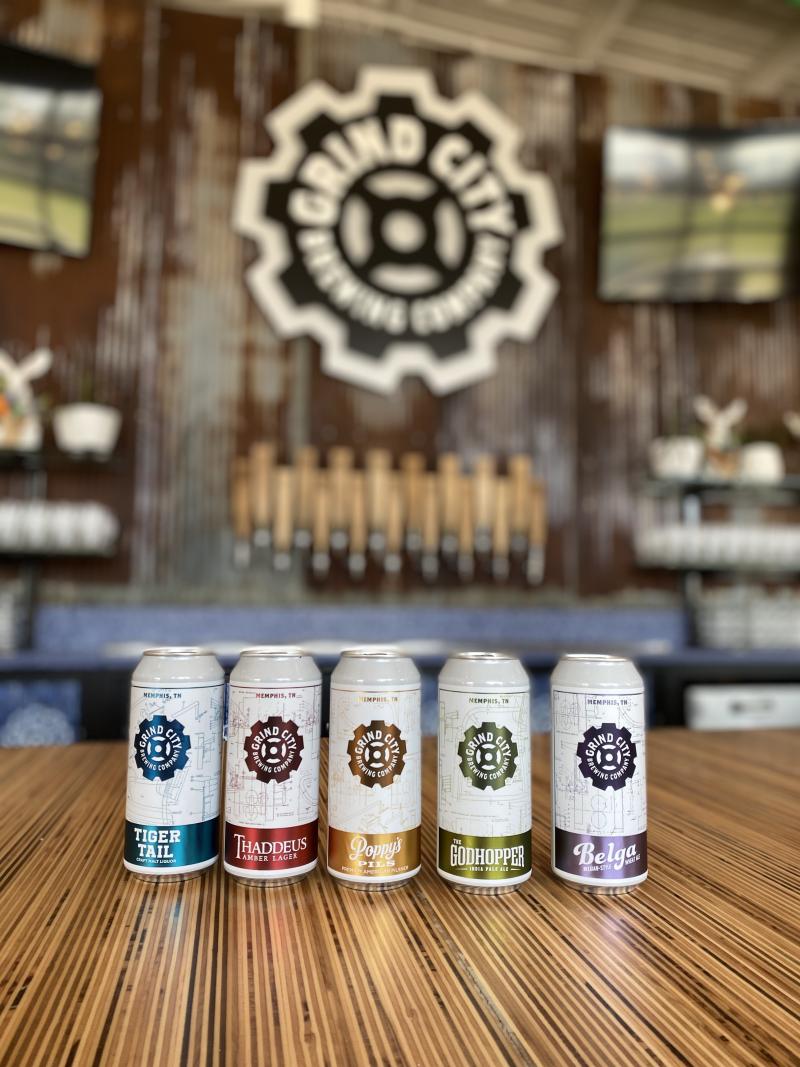 five grind city beers sit on brewery counter with grind city logo in background