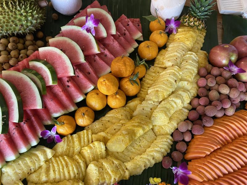 cut up fruit piled together: watermelon, oranges, pineapples