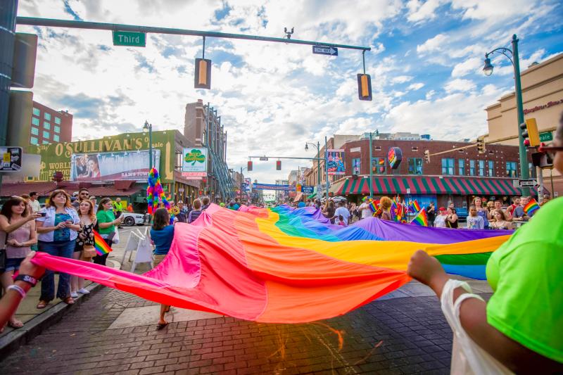 rainbow flag being walked down beale street during pride festival
