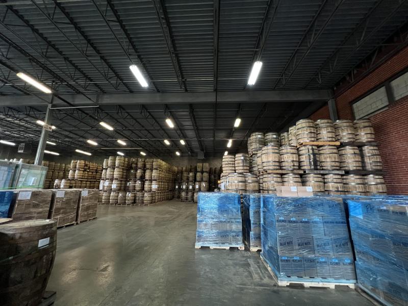 wide photo of production facility with hundreds of bourbon barrels
