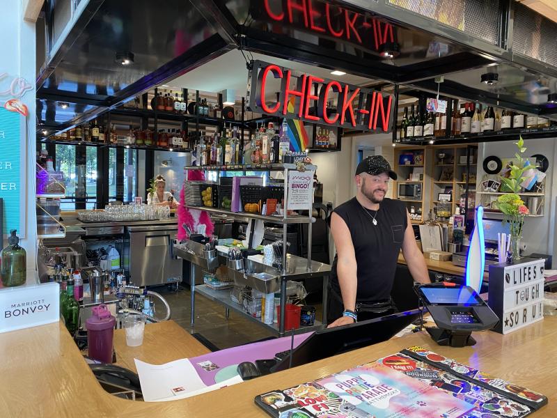moxy employee smiles behind check-in desk
