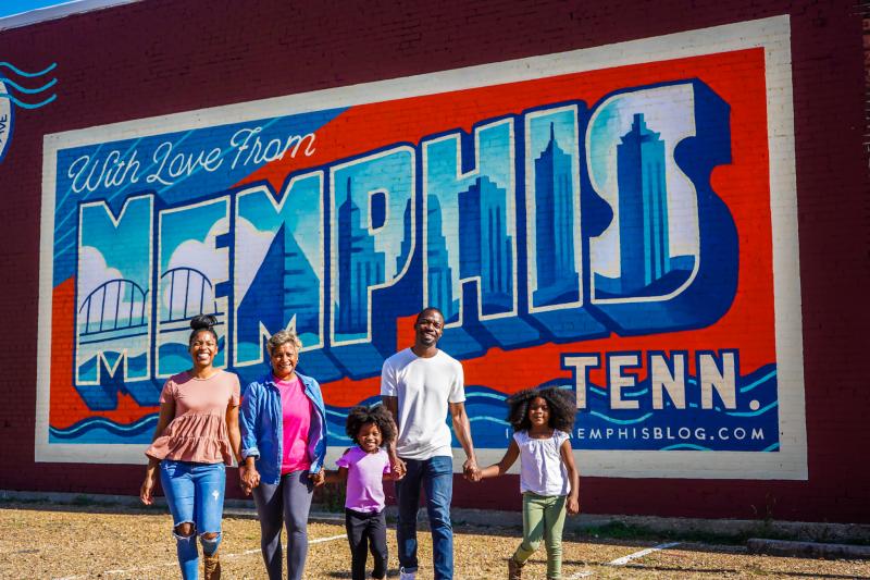 family of five stands in front of with love from memphis mural