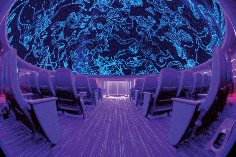 Wide shot of planetarium at MoSH with empty seats and ceiling lit up