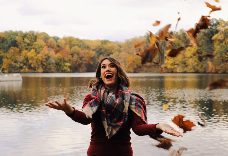 woman throwing leaves in air Fall at MeemanShelby Forest State Park