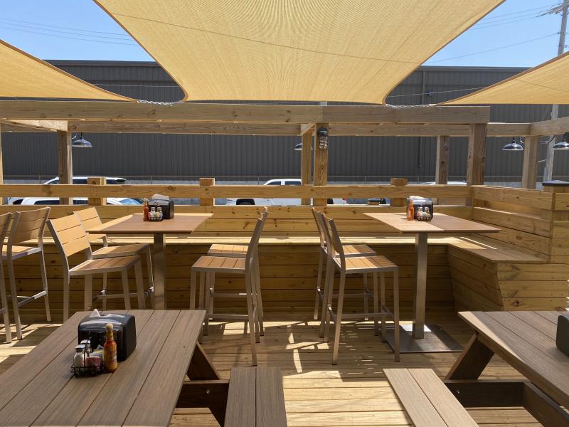 several outdoor patio tables with canopies overhead