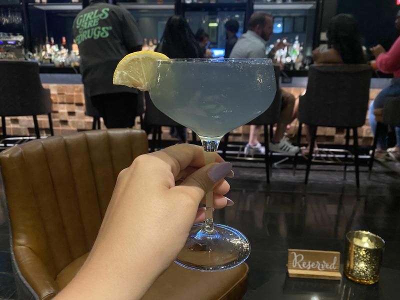 glittery cocktail held up at beck &amp; call