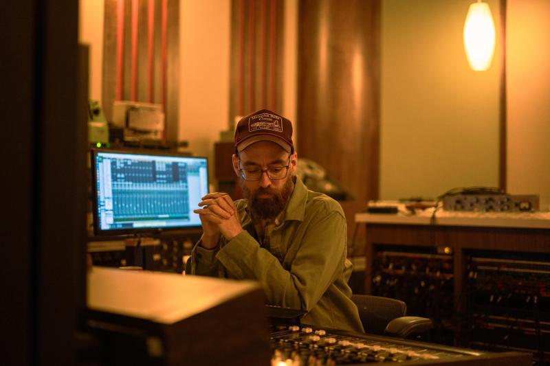 Matt Ross-Spang sits at recording board in studio
