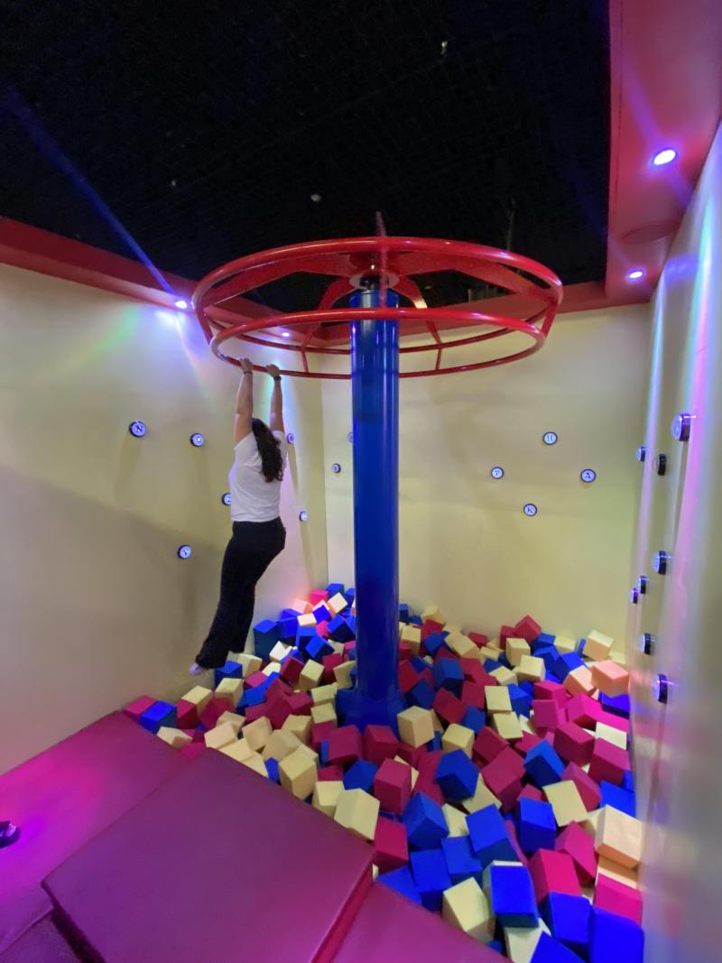 woman holds from spinning top in game room