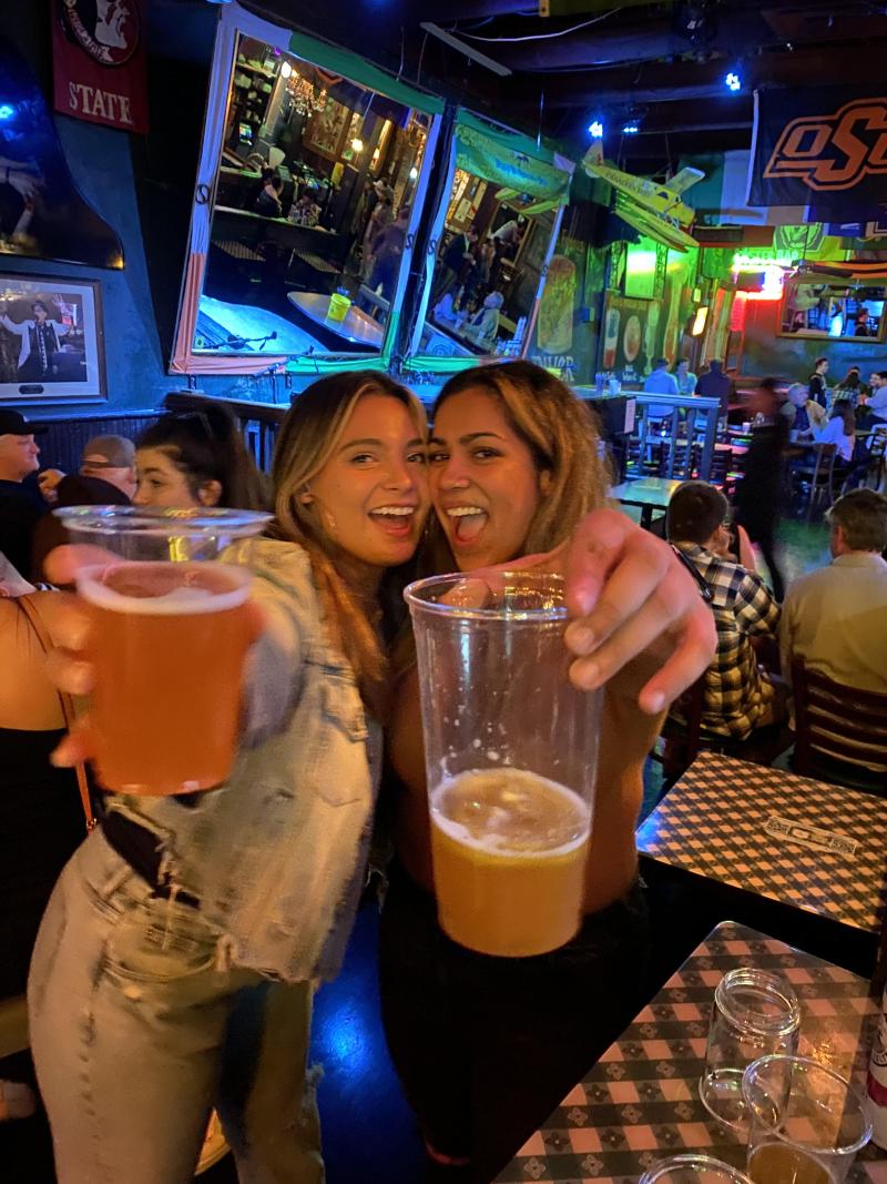 two girls pose with beers at silky