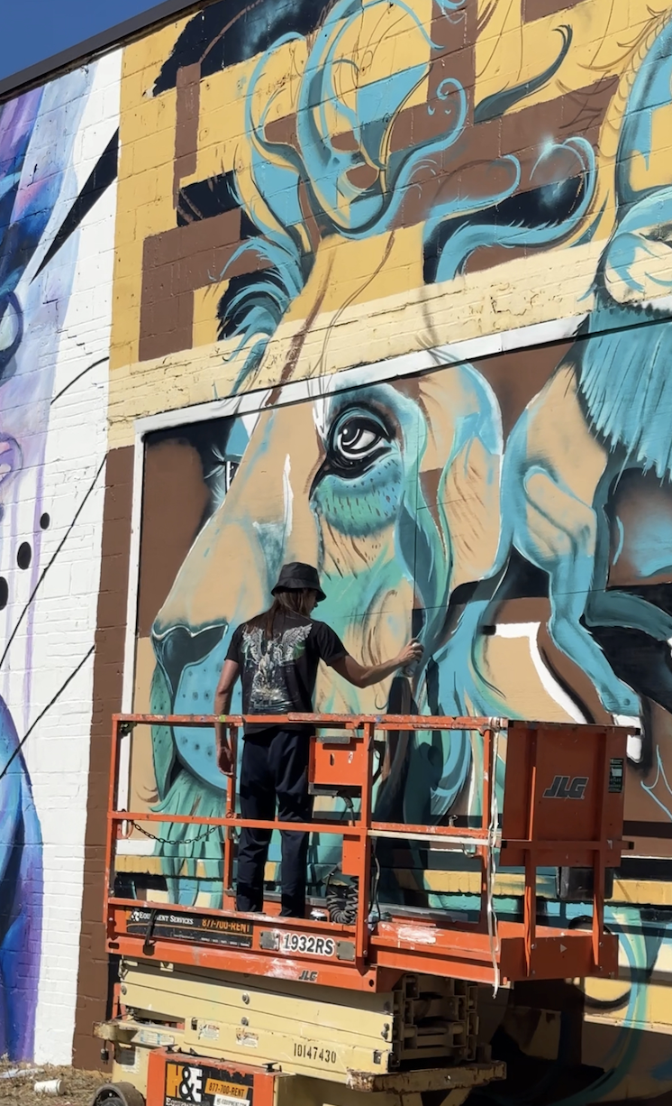 Paint Memphis mural street art | man spray painting