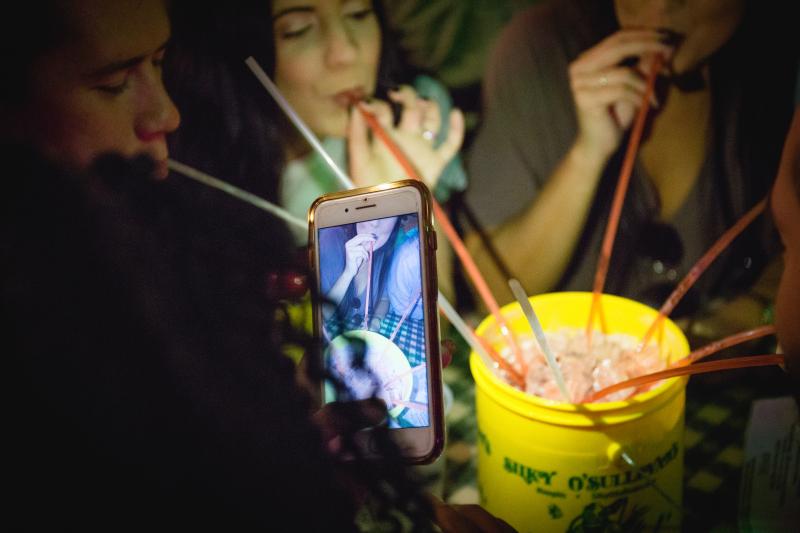 close up of people drinking out of Diver drink bucket