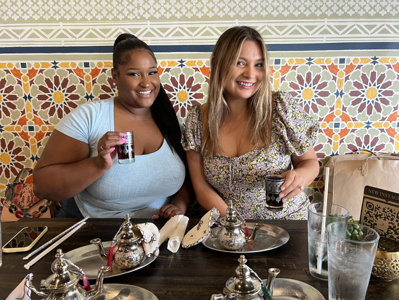 two girls pose with tea