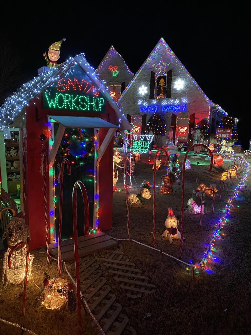 home decorated with christmas lights and Santa house