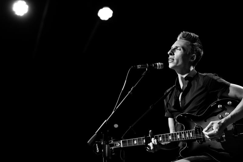 Chris Milam singing and playing guitar
