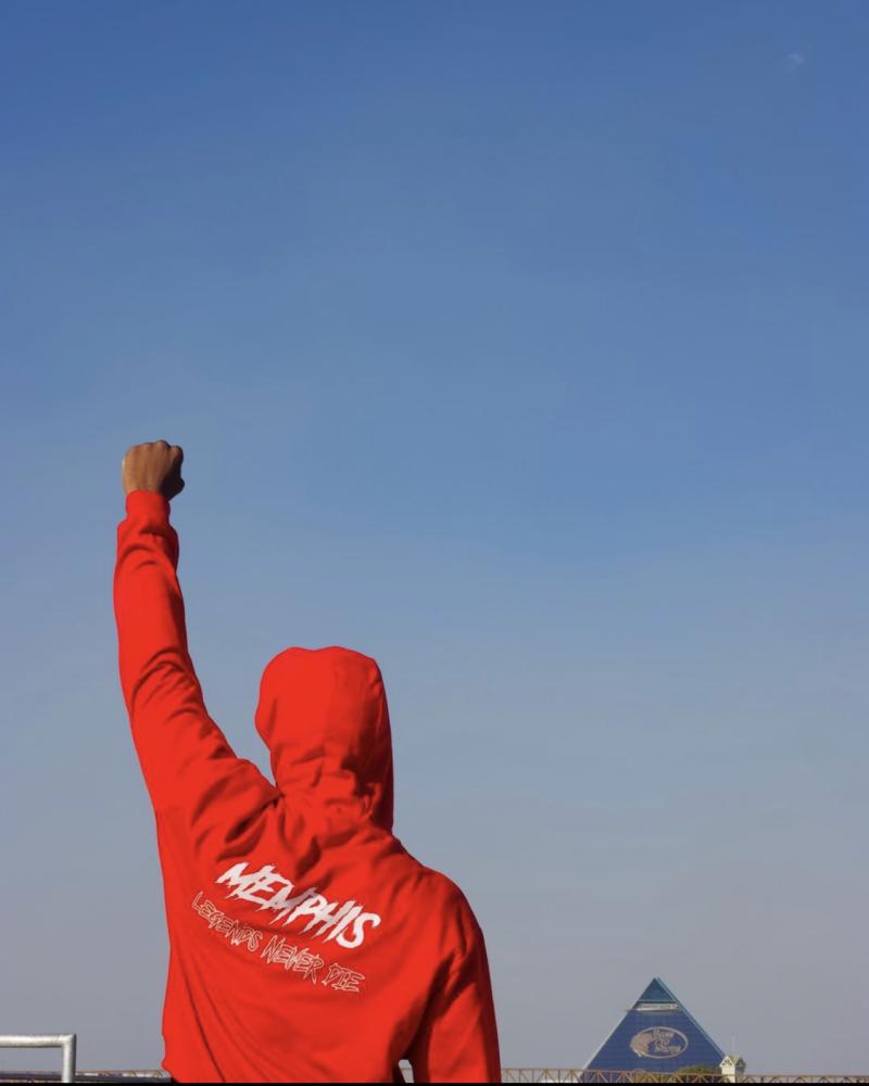 Danny Barlow holds fist in air in Memphis hoodie