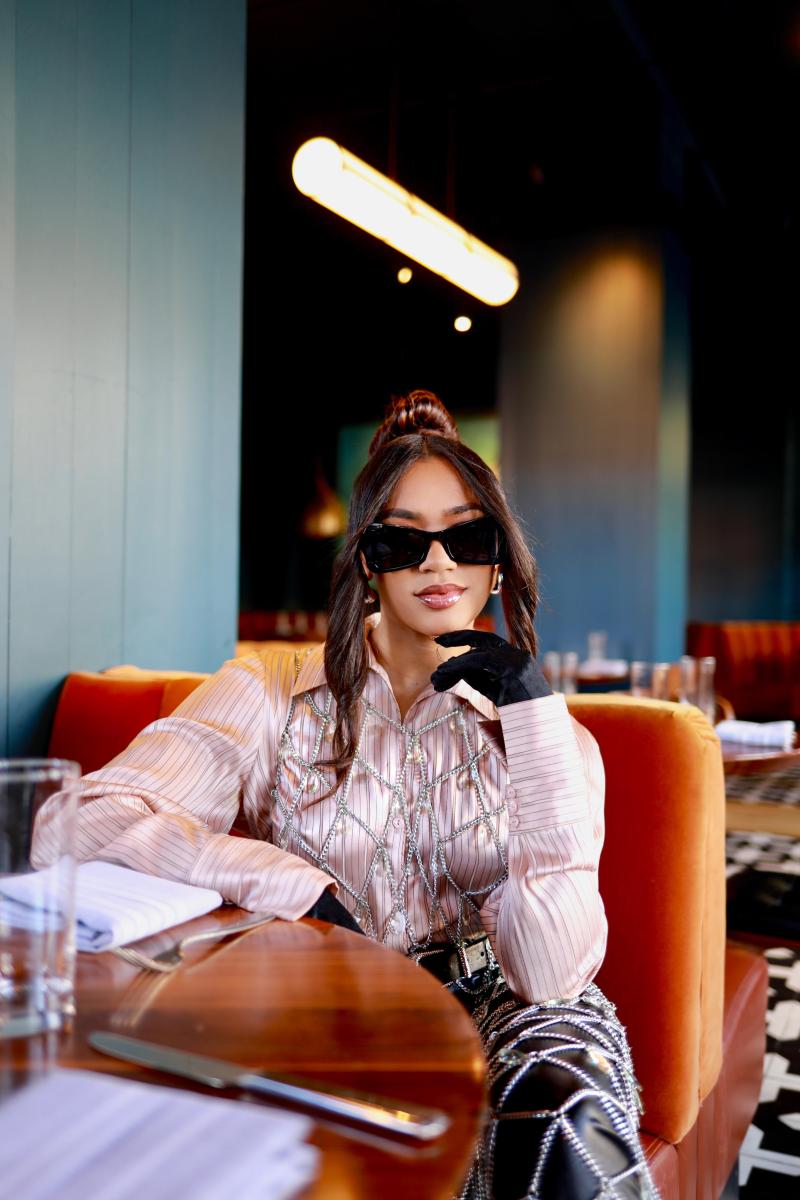 Caitlin McGill  posing with shades at restaurant