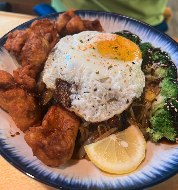 noodle bowl topped with egg and chicken