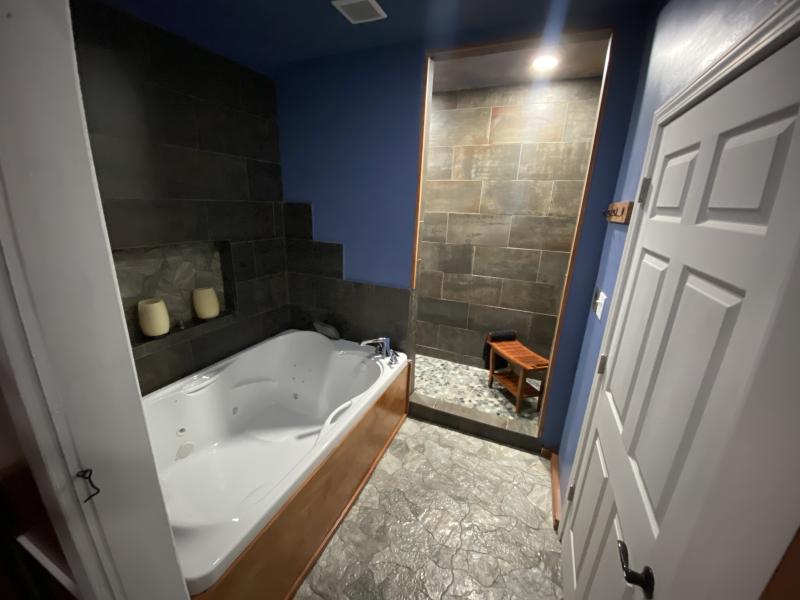 large bath spa with steam shower in background