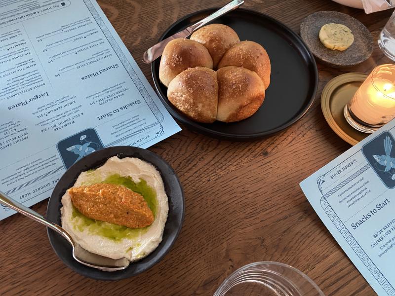 Freshly Baked Yeast Rolls with whipped garlic herb butter and whipped feta with sunflower Romesco