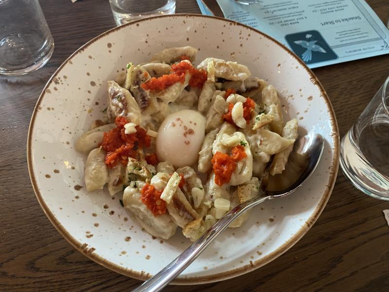 Homemade Gnocchi with a vidalia soubise, calabrian chiles, pickled garlic, and a one hour hen egg
