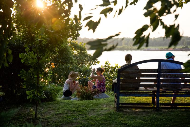 people enjoying outside at metal museum along the river
