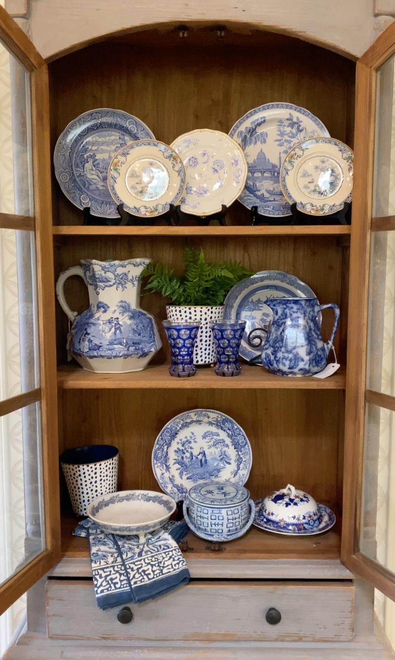 white and blue china on display
