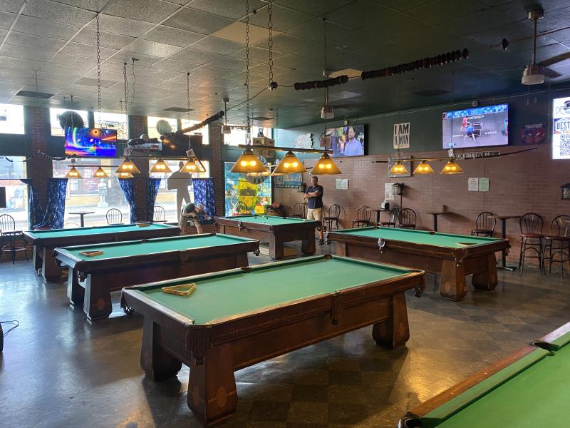 pool tables inside peoples bar, two men playing pool