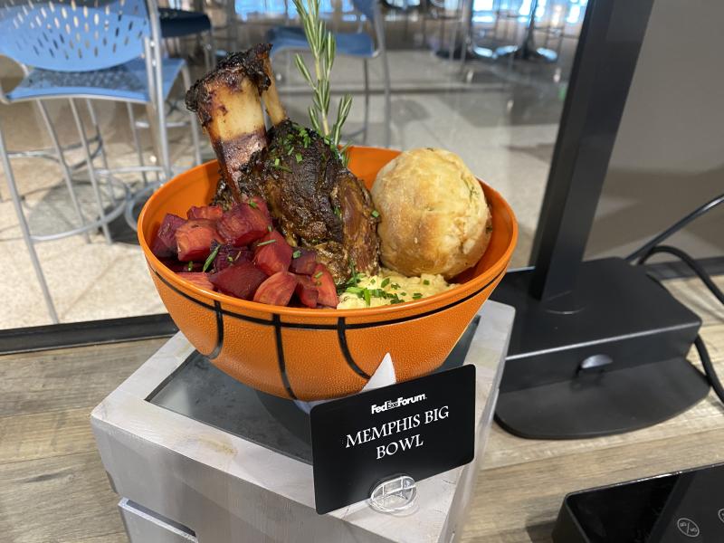souvenir basketball bowl filled with pork shank, grits, biscuit, veggies