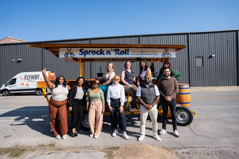 group photo of team next to peddle tavern