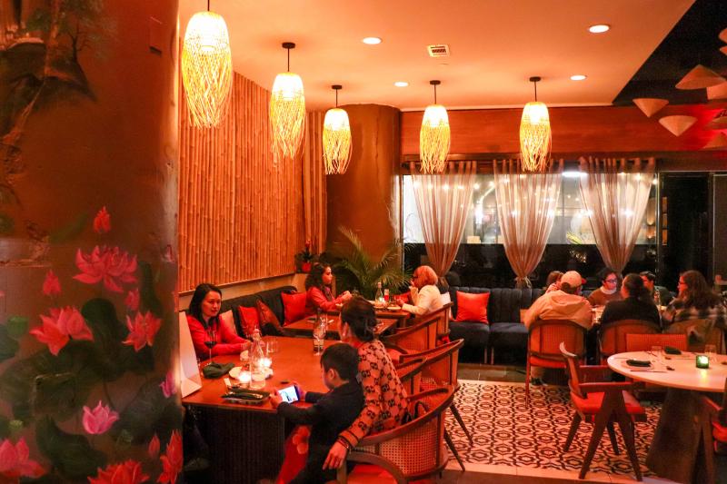 dining room dimly lit at Bao Toan with people eating at tables