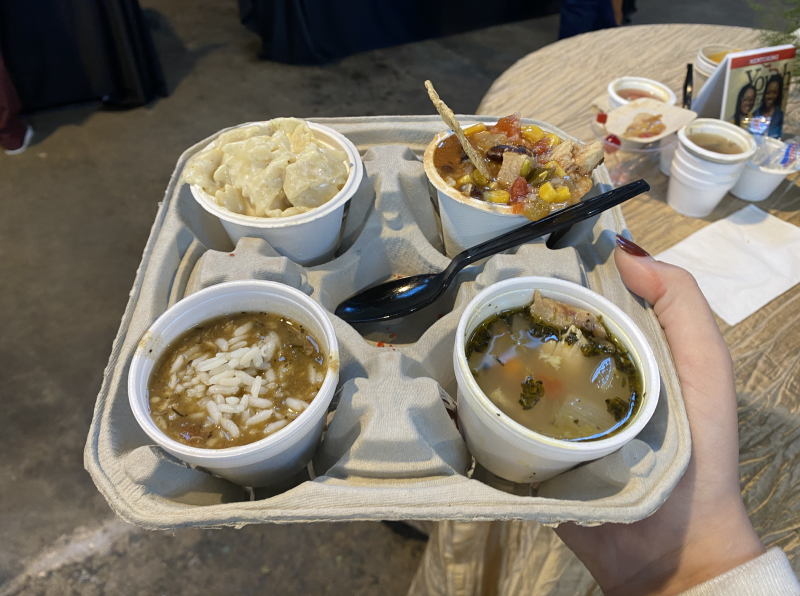 four varieties of soup on a drink holder