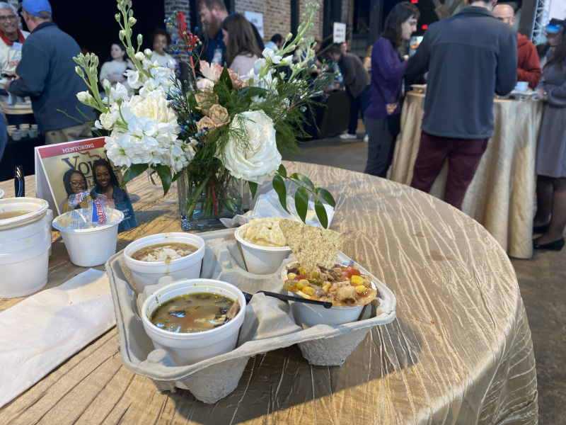 soups in drink holder sitting on table