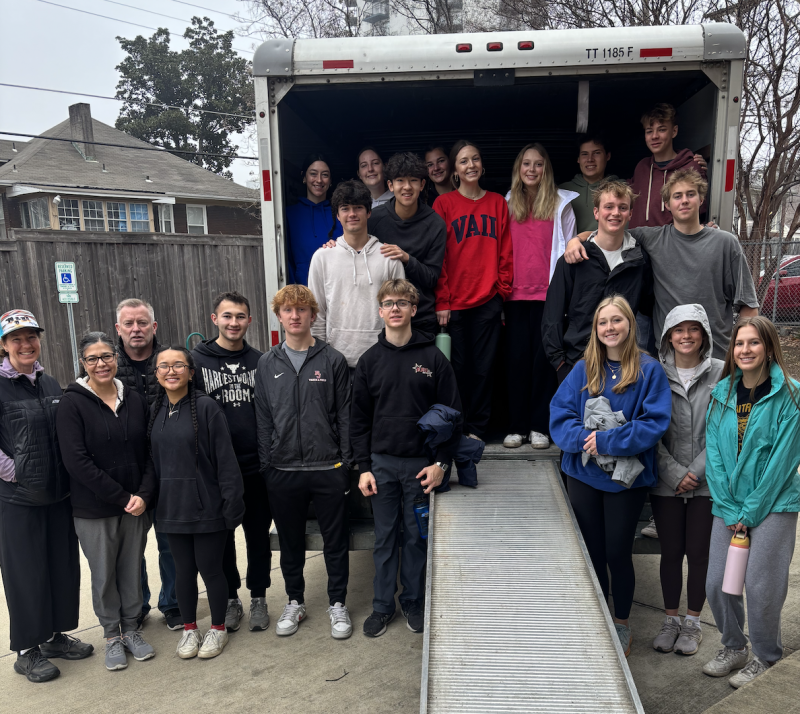 college students post for photo with moving truck